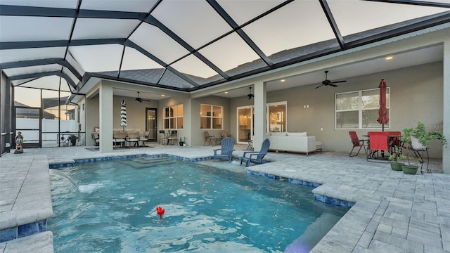 view of swimming pool with pool water feature, a lanai, ceiling fan, and a patio