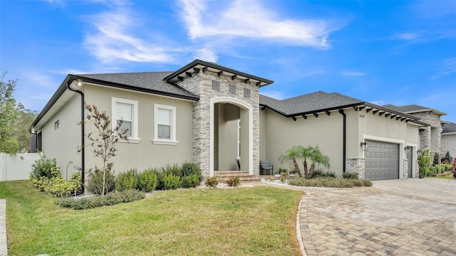 view of front facade with a front yard and a garage