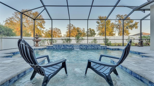 view of pool featuring pool water feature, a lanai, and a patio