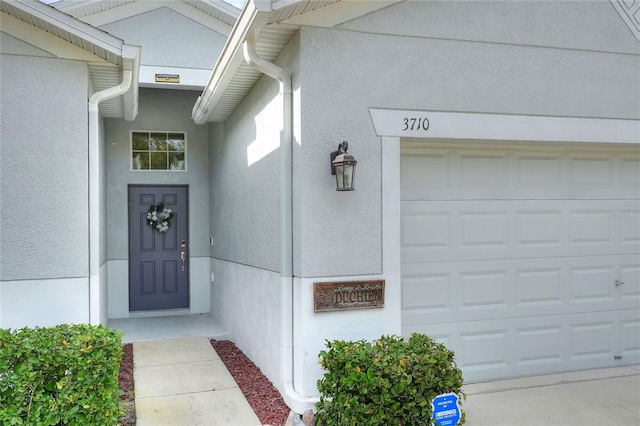 doorway to property with a garage