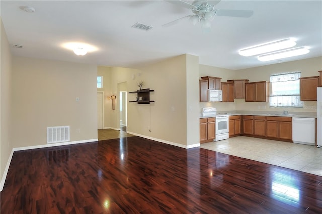 kitchen with ceiling fan, light hardwood / wood-style floors, white appliances, and sink