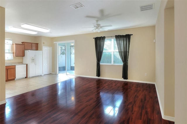 unfurnished living room with ceiling fan and light hardwood / wood-style flooring