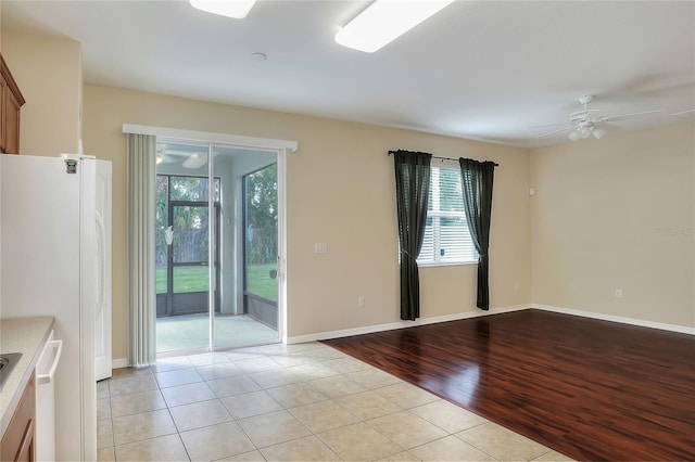 spare room featuring ceiling fan and light tile patterned floors