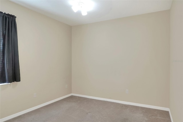 spare room featuring light colored carpet