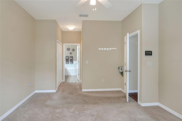 hallway featuring light carpet