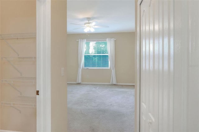 spare room featuring ceiling fan and light colored carpet