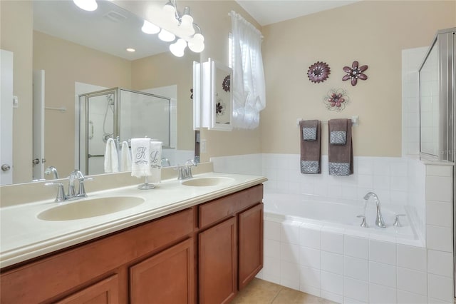 bathroom featuring tile patterned floors, vanity, and shower with separate bathtub