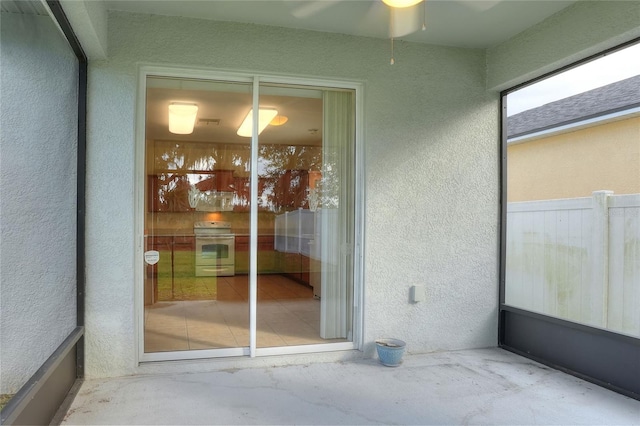 entrance to property featuring ceiling fan