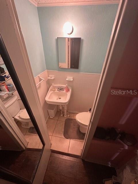 bathroom with tile patterned flooring, sink, and toilet