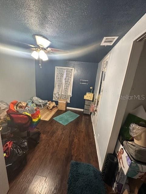 bedroom featuring dark wood-type flooring and a textured ceiling