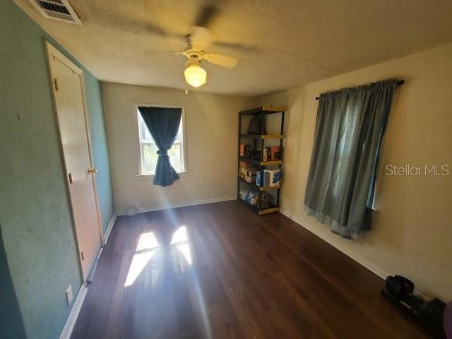 spare room with ceiling fan and dark hardwood / wood-style flooring