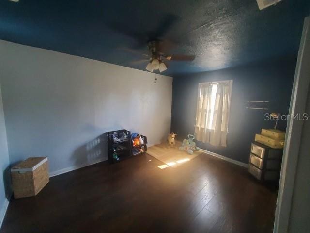 spare room featuring dark hardwood / wood-style floors and ceiling fan