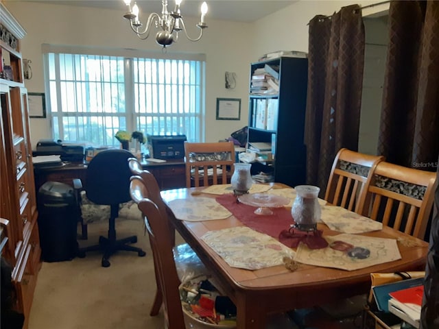 dining room featuring carpet floors and a chandelier