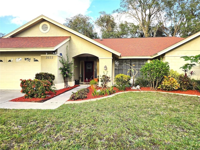 ranch-style house featuring a garage and a front lawn