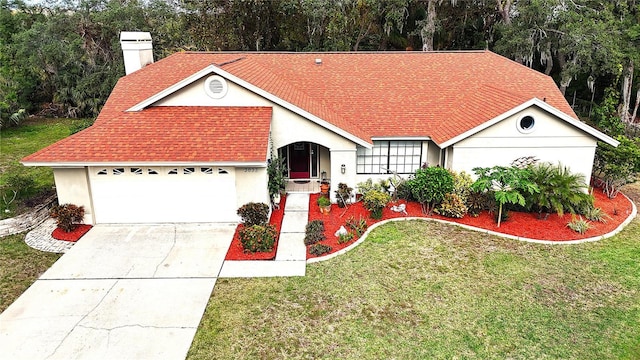 view of front facade featuring a front lawn and a garage