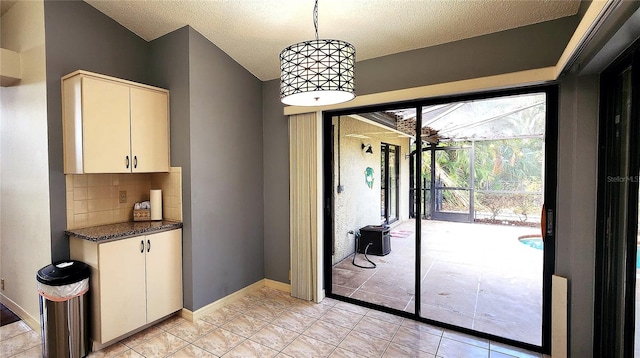 interior space featuring light tile patterned floors and a textured ceiling