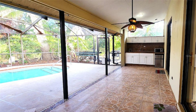 view of swimming pool with ceiling fan