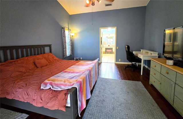 bedroom with dark hardwood / wood-style floors and ensuite bath