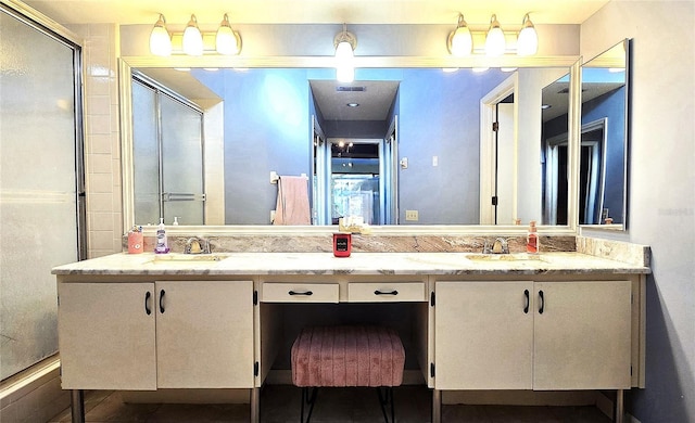 bathroom with vanity and a shower with shower door