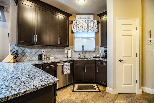 kitchen with dishwasher, dark brown cabinets, light stone countertops, and sink