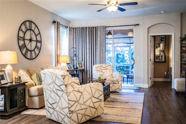 living room featuring dark hardwood / wood-style floors and ceiling fan