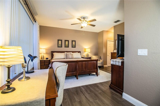 bedroom with dark hardwood / wood-style floors and ceiling fan