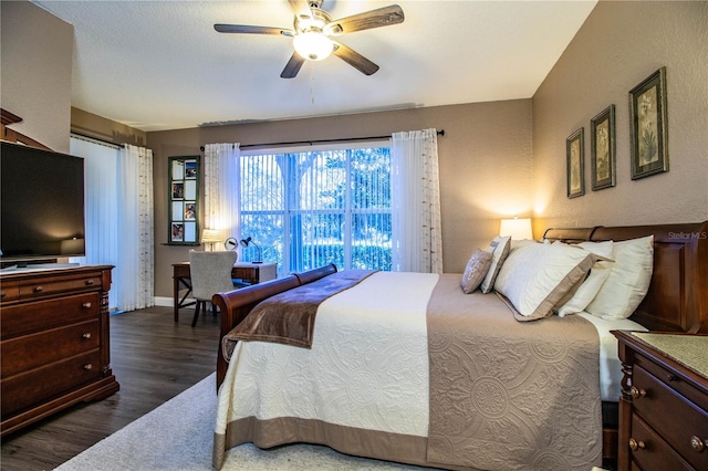 bedroom featuring ceiling fan and dark wood-type flooring