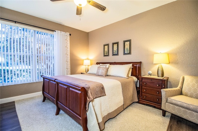 bedroom with ceiling fan and light hardwood / wood-style flooring