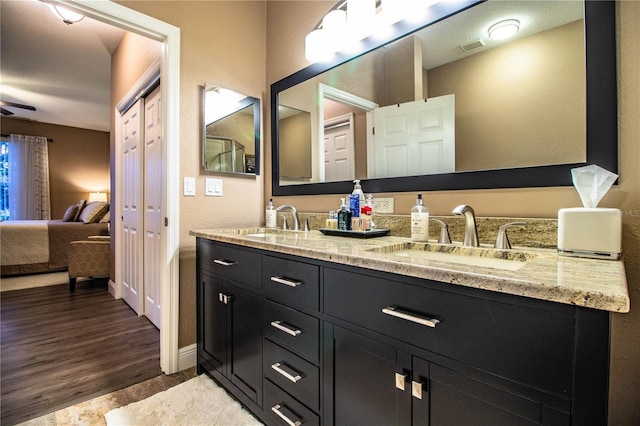 bathroom with vanity, hardwood / wood-style flooring, and ceiling fan