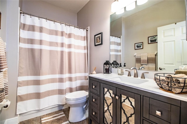 bathroom featuring vanity, curtained shower, and toilet