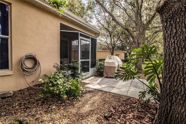 view of yard featuring a patio area and a sunroom