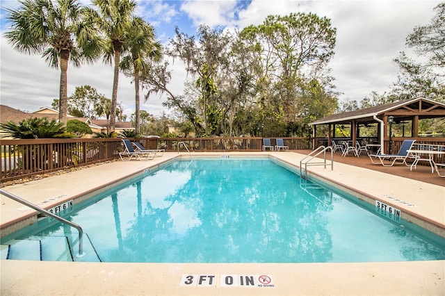 view of swimming pool featuring a gazebo and a patio area