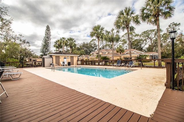 view of pool featuring a patio, an outdoor structure, and a deck