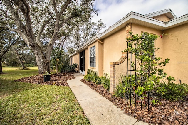 view of side of home with a yard