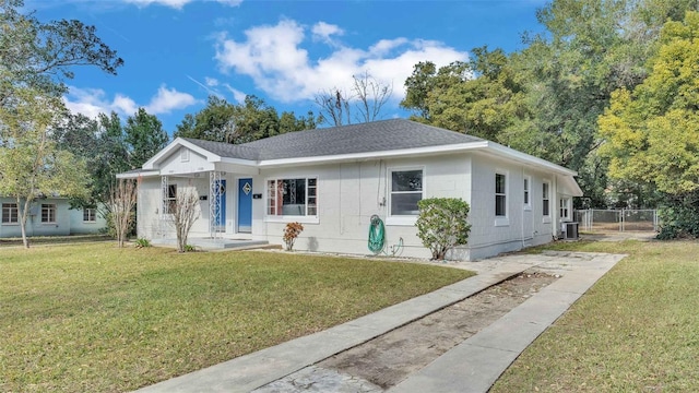 view of front of house with cooling unit, covered porch, and a front yard