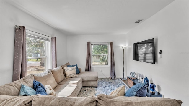 living room with a wealth of natural light and light hardwood / wood-style floors