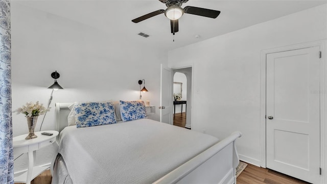 bedroom with hardwood / wood-style floors and ceiling fan