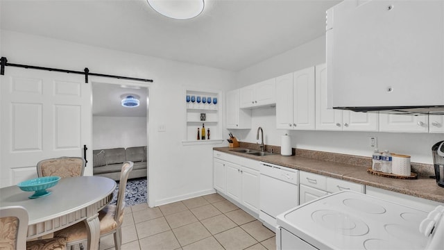 kitchen with white cabinetry, dishwasher, sink, a barn door, and stove