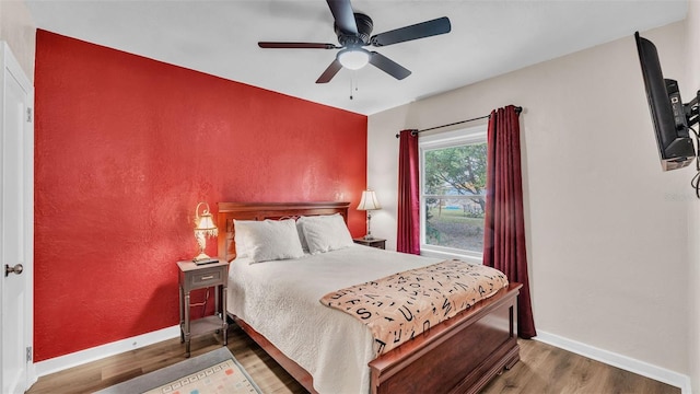 bedroom featuring hardwood / wood-style floors and ceiling fan