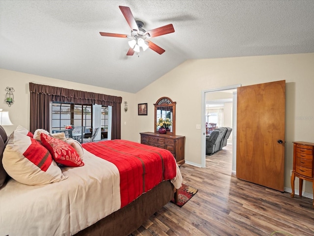 bedroom with access to exterior, a textured ceiling, ceiling fan, wood-type flooring, and lofted ceiling