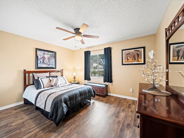 bedroom featuring ceiling fan, dark hardwood / wood-style flooring, and a textured ceiling