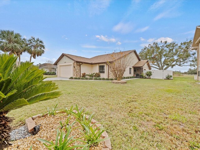 ranch-style house featuring a front yard and a garage