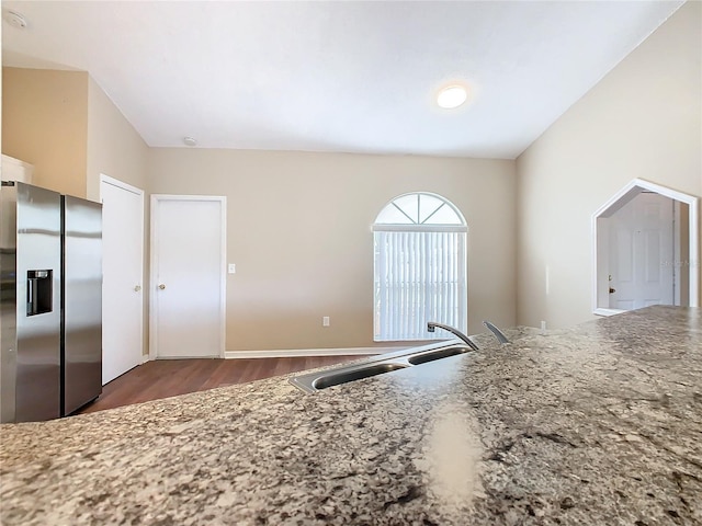 kitchen with sink, stainless steel fridge with ice dispenser, and dark hardwood / wood-style flooring