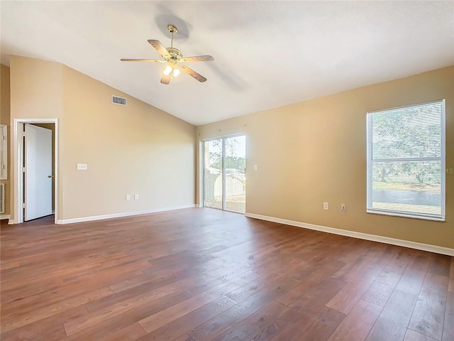 spare room featuring ceiling fan, dark wood-type flooring, and lofted ceiling