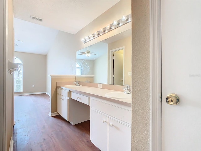 bathroom with ceiling fan, vanity, lofted ceiling, and hardwood / wood-style flooring