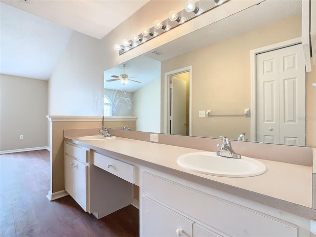 bathroom with ceiling fan, vanity, vaulted ceiling, and hardwood / wood-style flooring