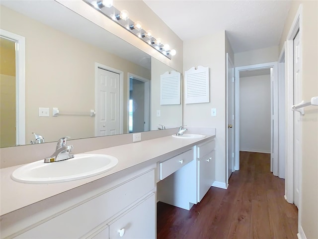 bathroom featuring hardwood / wood-style flooring and vanity