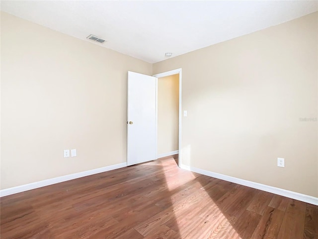 empty room with hardwood / wood-style floors