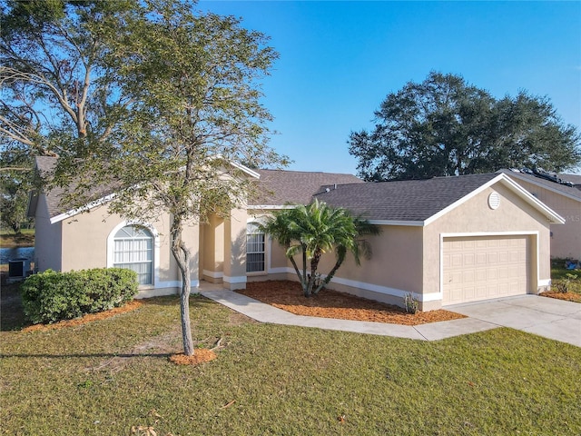 ranch-style house with a front yard, a garage, and central AC