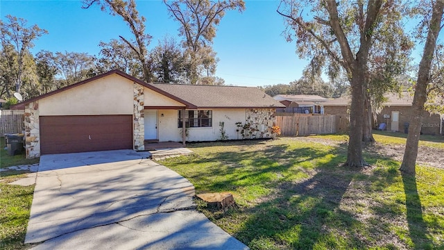 ranch-style home featuring a garage and a front lawn